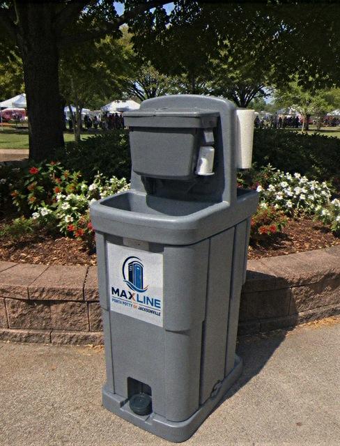 Portable handwashing station set up on a paved path at a public event